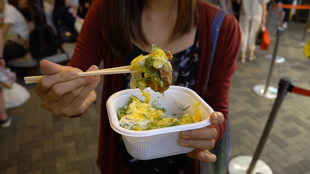 takoyaki covered in raw egg, bonito flakes and mayonaise