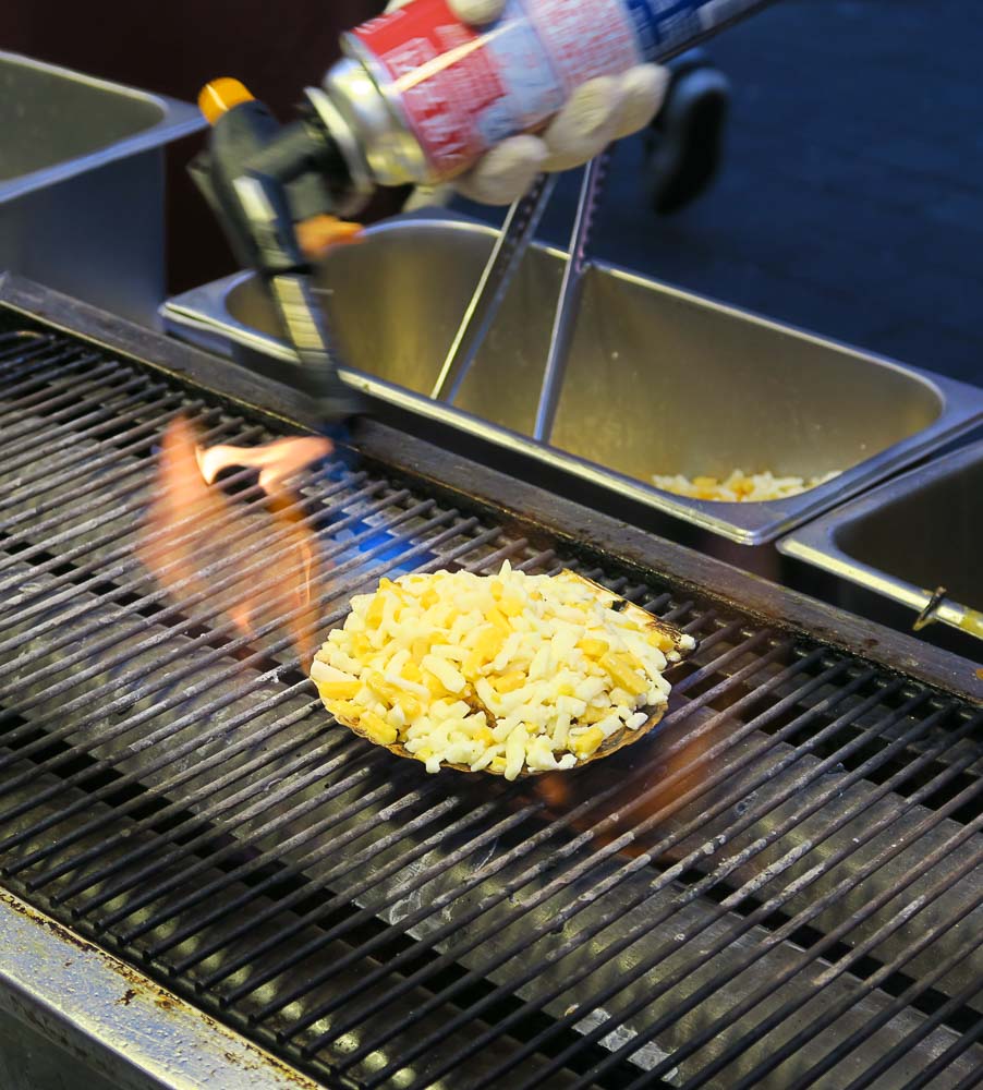 A scallop being seared by torch - Food in Seoul