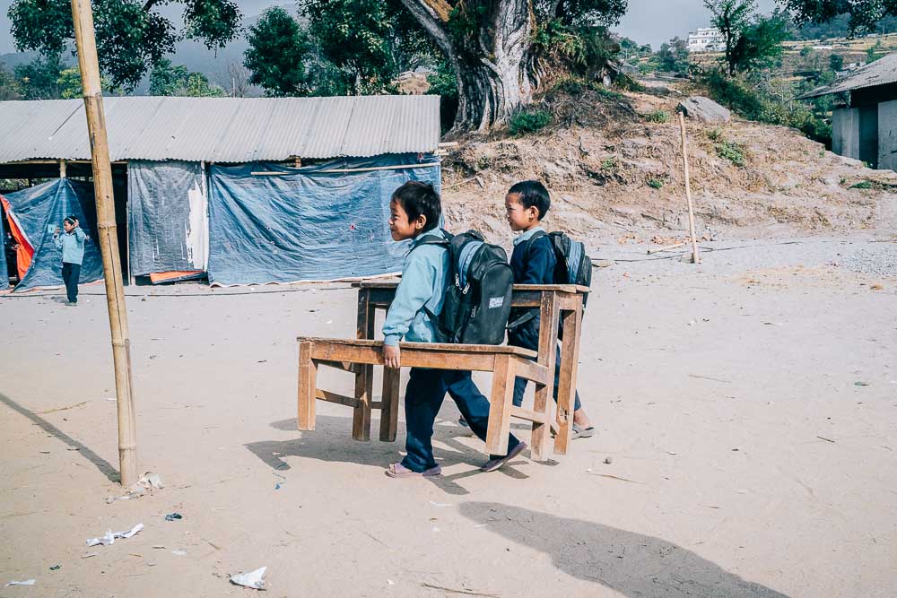 Students carrying their tables to school - Travel photojournalism