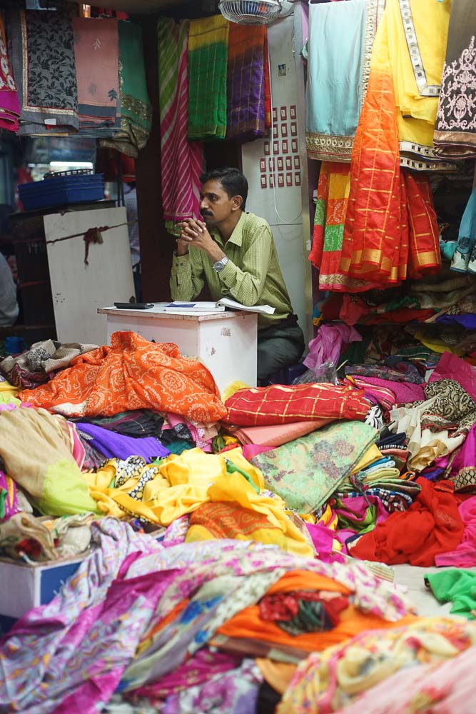Shopkeeper selling saree - Chennai Guide