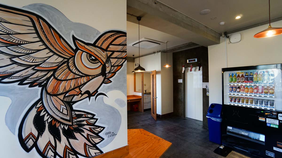 Owl artwork in common room by Coco - wise owl hostels tokyo review 5