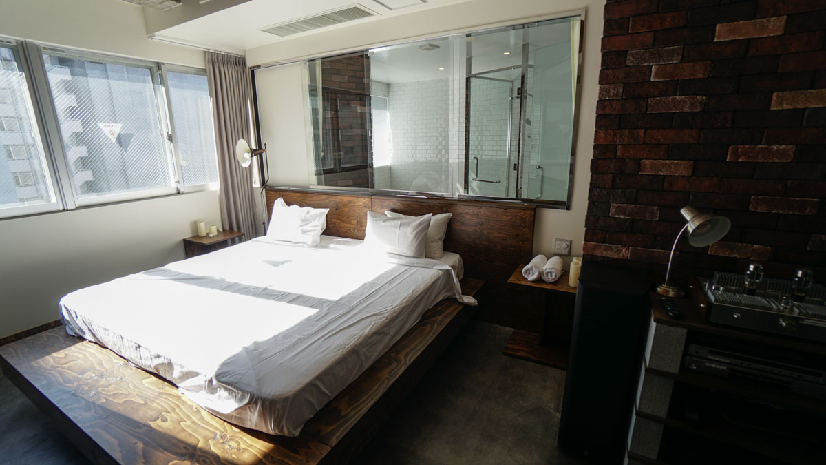 Master bedroom and bathroom in background in penthouse apartment - wise owl hostels tokyo review 7