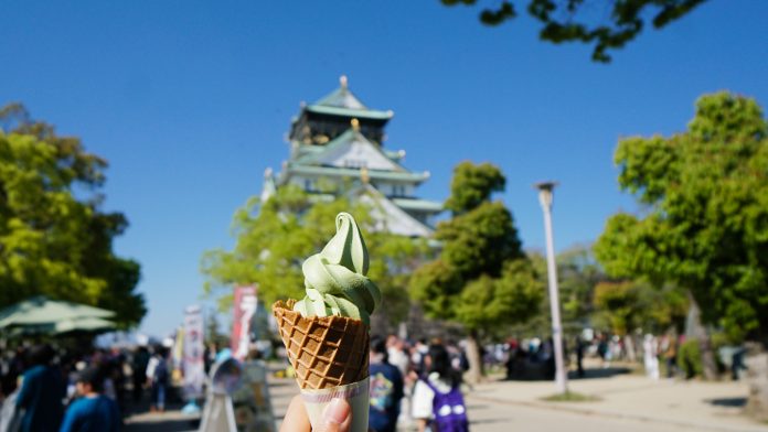 Featured - Japan budget JR Pass Itinerary Matcha ice cream in front of Osaka Castle - JR Pass Japan Budget Itinerary