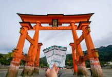 Holding up the Kansai-hiroshima JR Pass against the Miyajima Torii gate - Japan JR Pass guide - Singapore