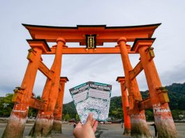 Holding up the Kansai-hiroshima JR Pass against the Miyajima Torii gate - Japan JR Pass guide - Singapore
