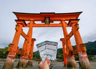 Holding up the Kansai-hiroshima JR Pass against the Miyajima Torii gate - Japan JR Pass guide - Singapore
