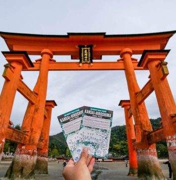 Ultimate JR Pass Singapore Guide — Step-by-Step Guide and New Updates (2024) Holding up the Kansai-hiroshima JR Pass against the Miyajima Torii gate - Japan JR Pass guide - Singapore