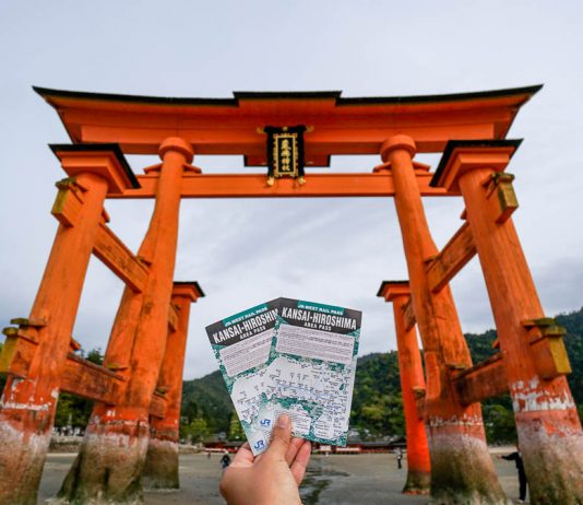 Ultimate JR Pass Singapore Guide — Step-by-Step Guide and New Updates (2024) Holding up the Kansai-hiroshima JR Pass against the Miyajima Torii gate - Japan JR Pass guide - Singapore