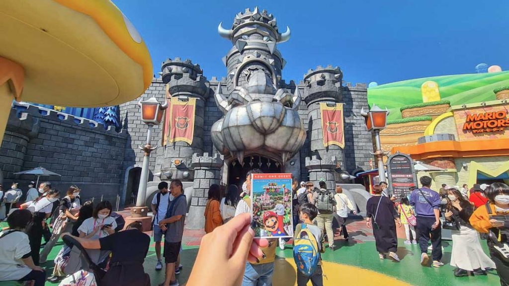 Hand Holding Super Nintendo World Ticket - USJ Osaka Guide