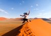 Jumping for joy at Dune, Namibia - travel solo for a year