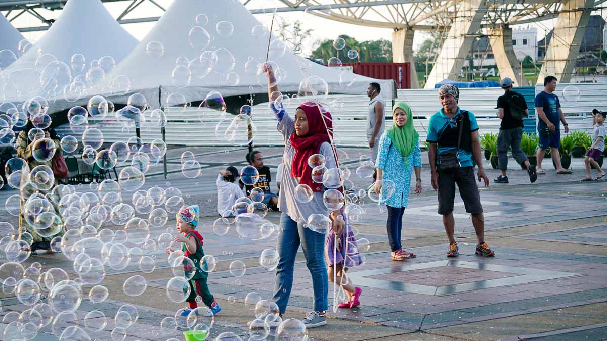 Waterfront playing with bubbles - Kuching Itinerary