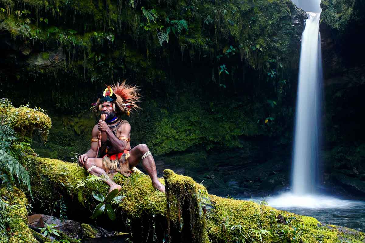 Papua New Guinea Aboriginal by waterfall - Visas Every Singaporean Wants