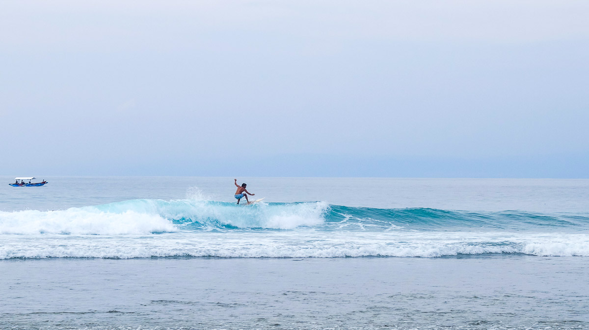 Surfer at Suluban Beach - Nusa Dua and Uluwatu Guide
