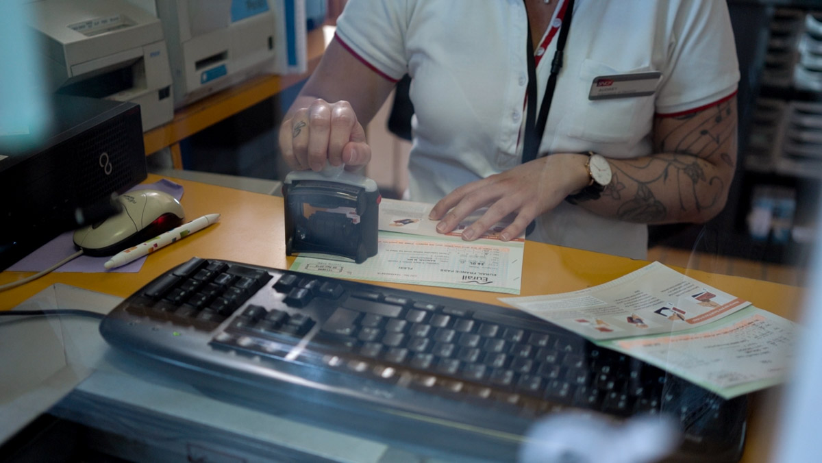 SNCF train staff validating eurail passes - France Itinerary