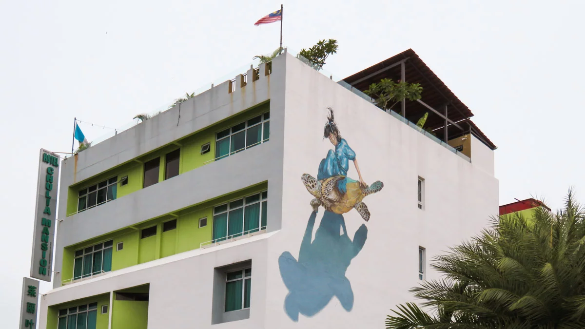 Girl on turtle mural - Penang Day trip guide