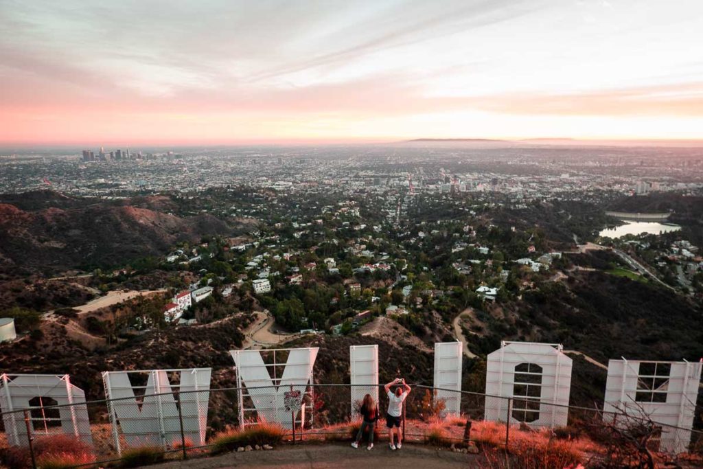 Couple Taking Photos at Hollywood Sign - 3-Day Los Angeles Travel Guide