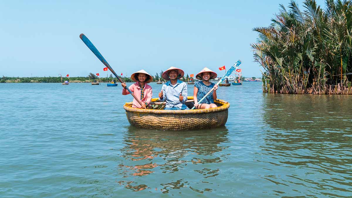 3 people in traditional Vietnamese conical hats in a Basket Boat - Central Vietnam Itinerary