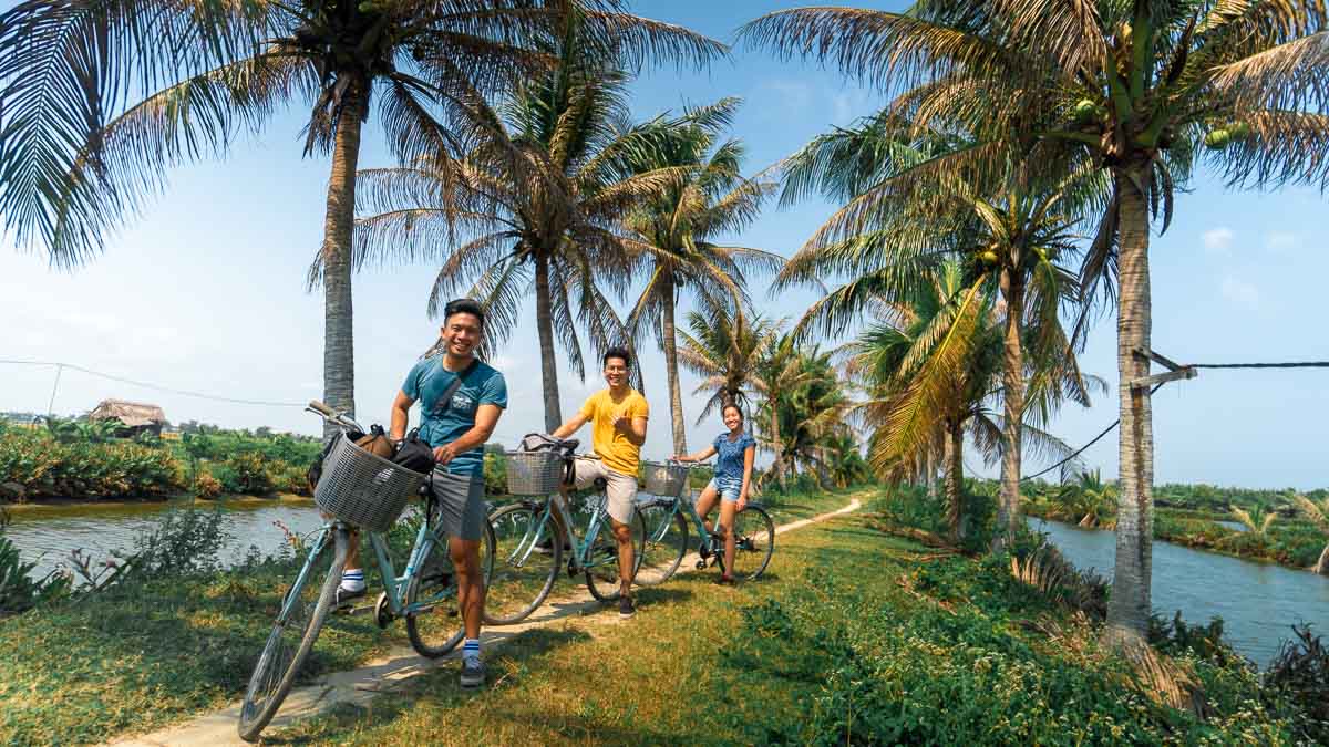 3 people on bicycles in the Coconut Forest cycling - Central Vietnam Itinerary