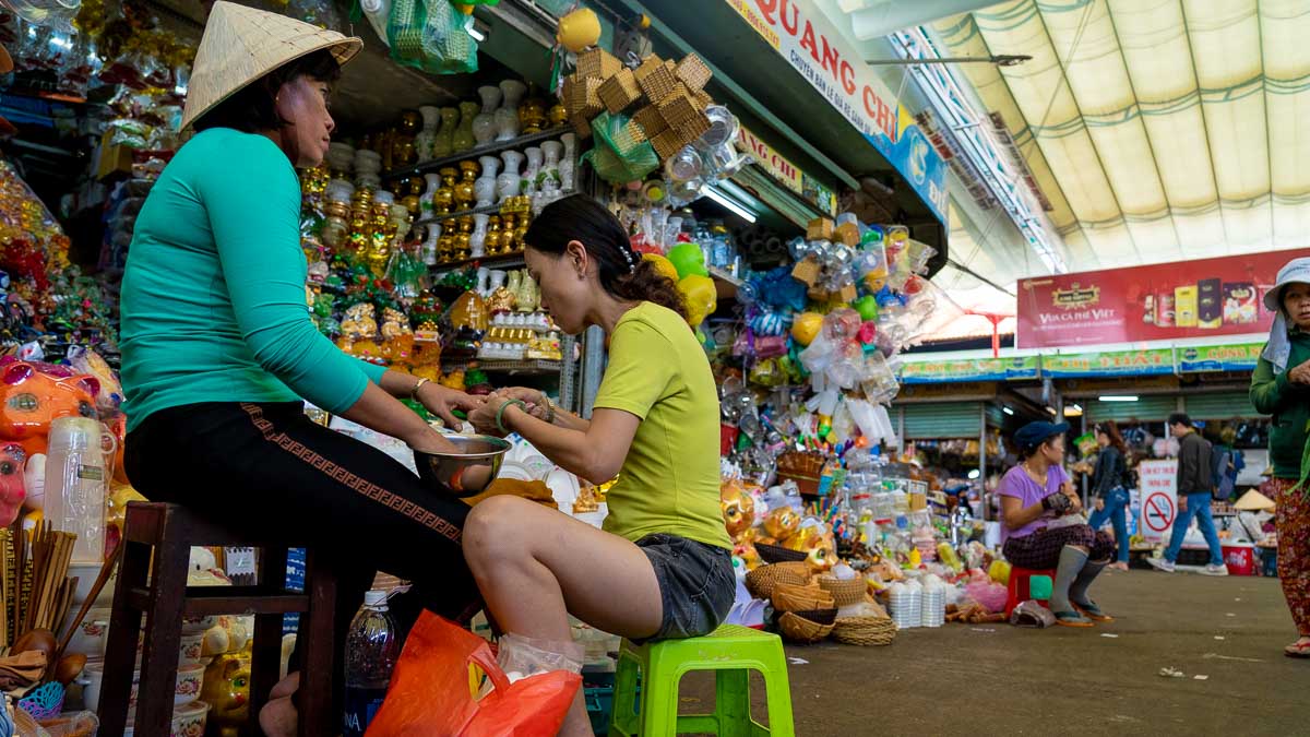 Lady giving manicure at Con Market - Central Vietnam Itinerary