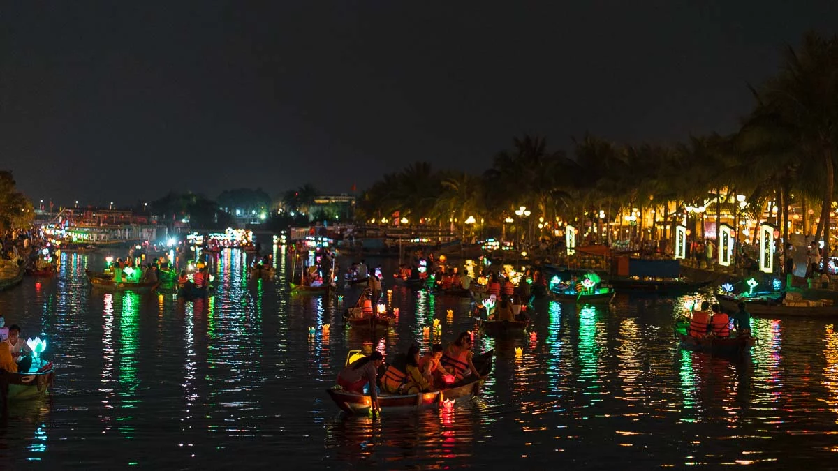 People on boats at night time at Hoi An Lantern Festival - Central Vietnam Itinerary