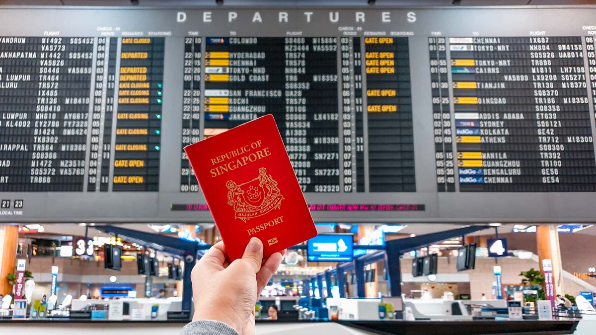 Singapore passport and airport departure board