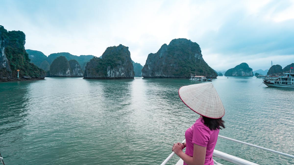 Girl in conical hat at halong bay - Day trips from Hanoi