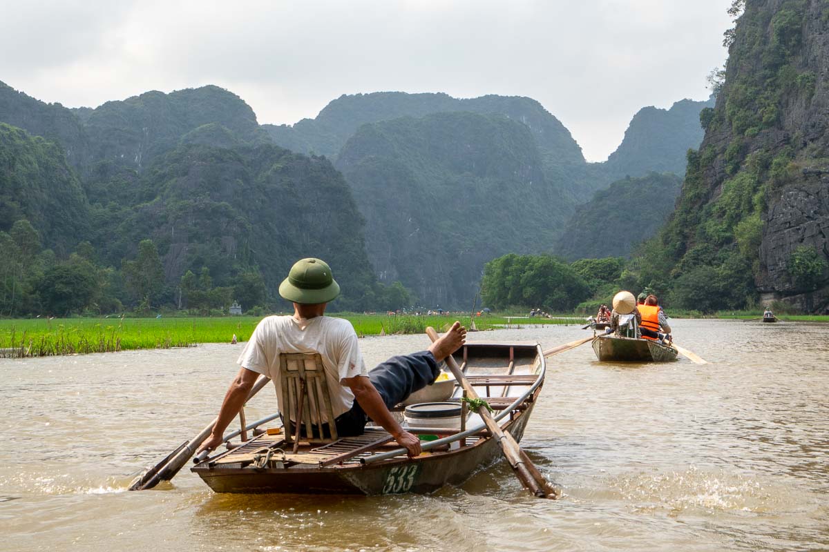 Vietnamese Man Rowing with Feet at Tam Coc River - Vietnam Itinerary