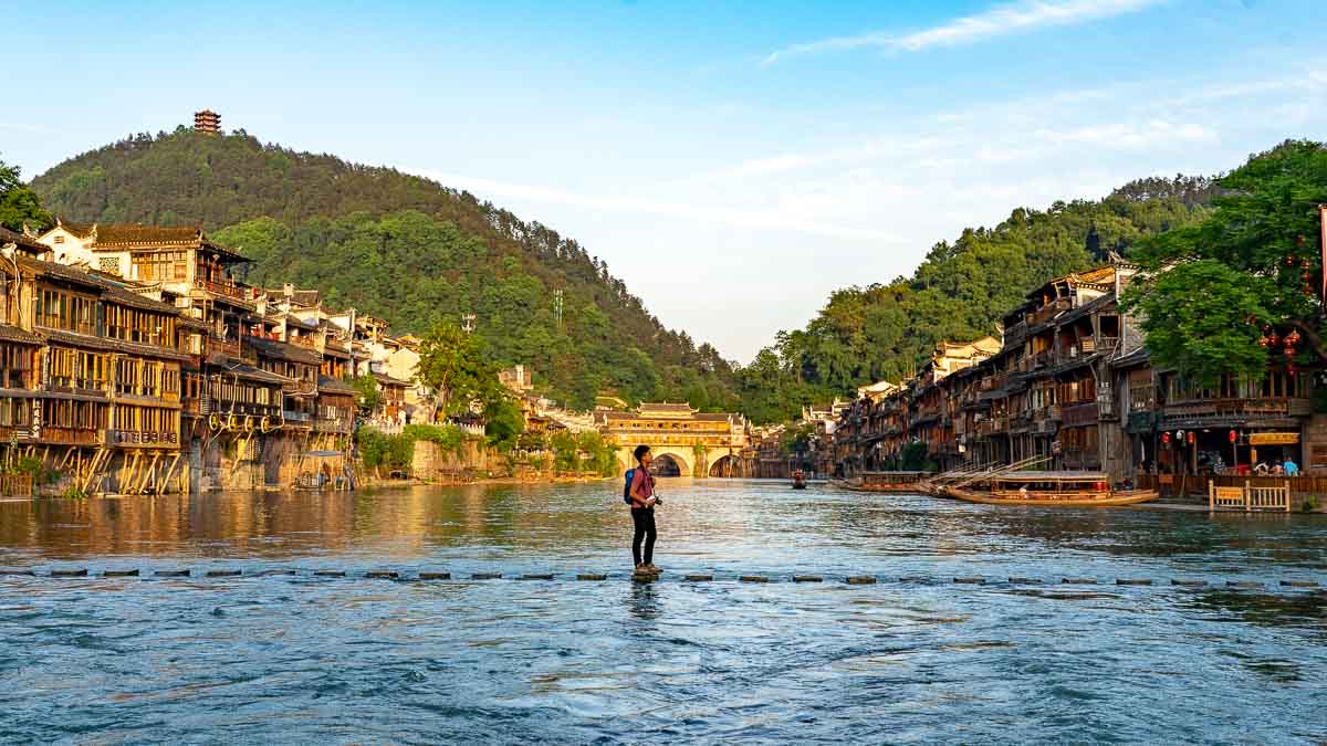 Renald on stepping stone bridge in Fenghuang - Central China Itinerary