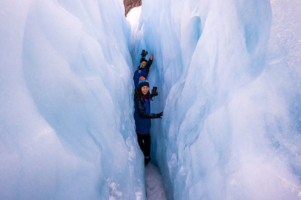 Squeezing through Crevice at Fox Glacier - New Zealand Best Things to Do