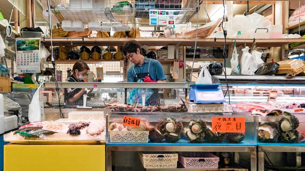 First Makishi Public market seafood stall selling Great green turban shell 夜光貝 - Okinawa food guide