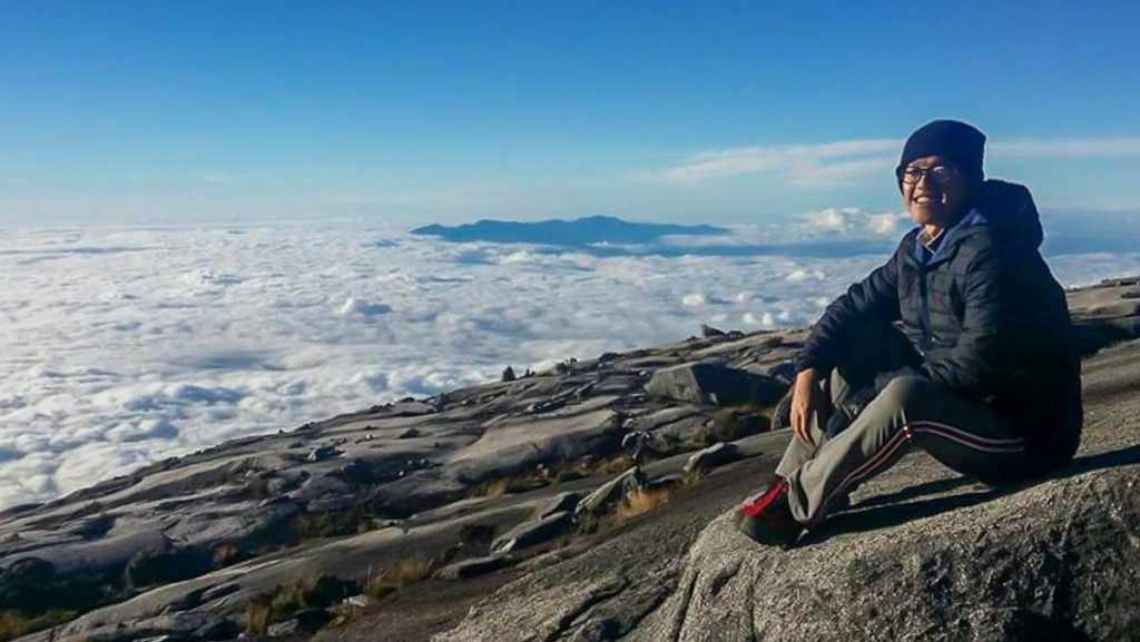 Sitting on Mount Kinabalu Summit 