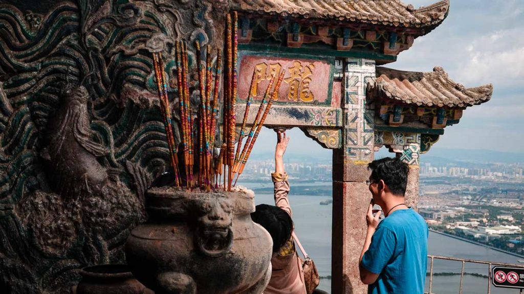 Touching bell of longmen for luck - China Things to do in Kunming city