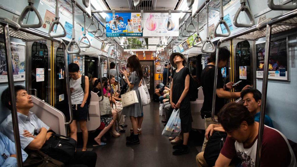 Commuters in a Tokyo Subway train - Japan Travel Tips Peak Season