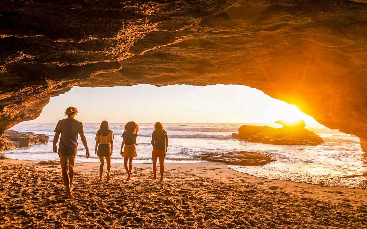 Friends walking along Caves Beach, NSW
