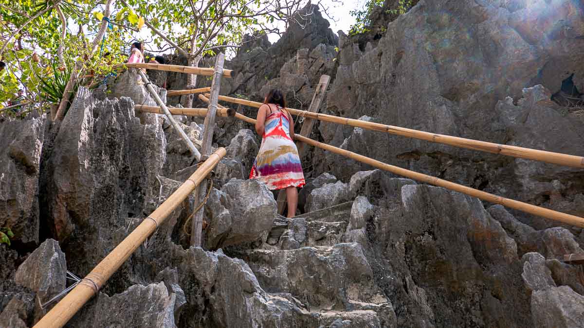 Girl climbing up to Matinloc Shrine - Things to do in Palawan