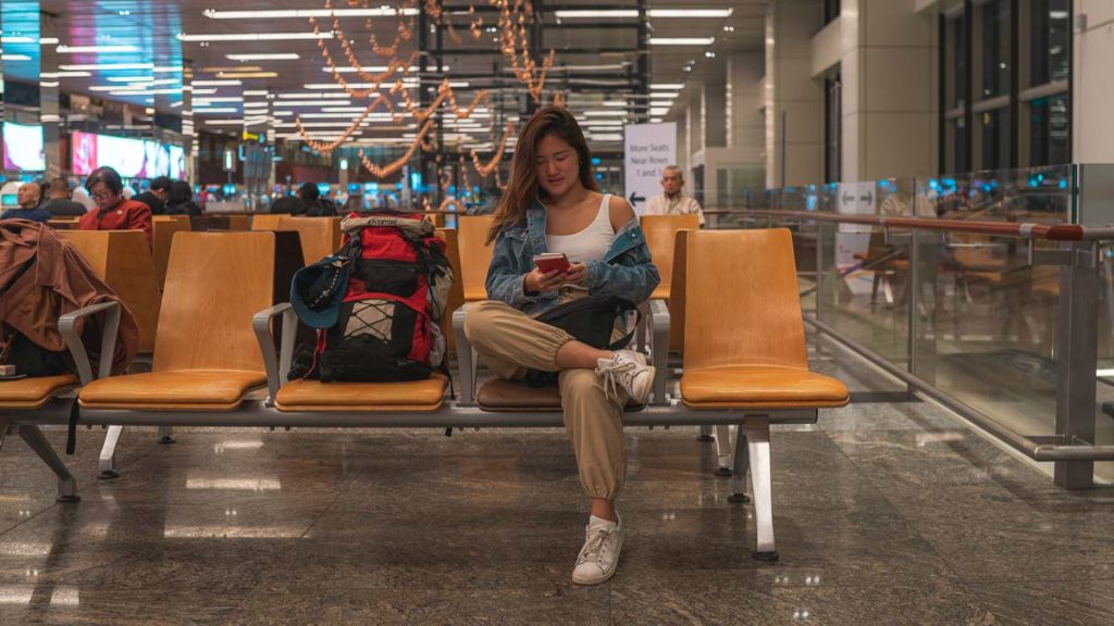 Person using NordVPN to access websites at Changi Airport - Travelling using NordVPN