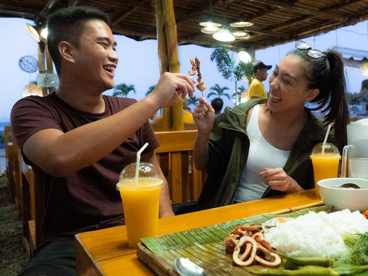 Friends having fun feasting on Boodle Fight at Baywalk - Puerto Princesa Itinerary 