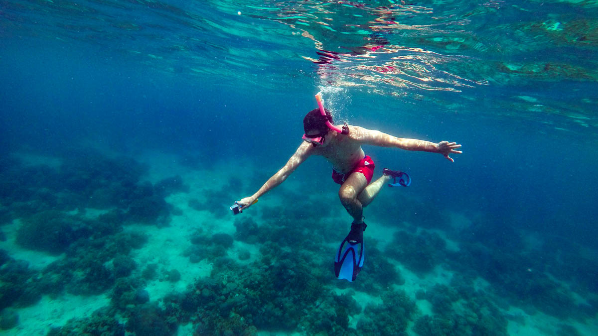 Man free diving tropical island