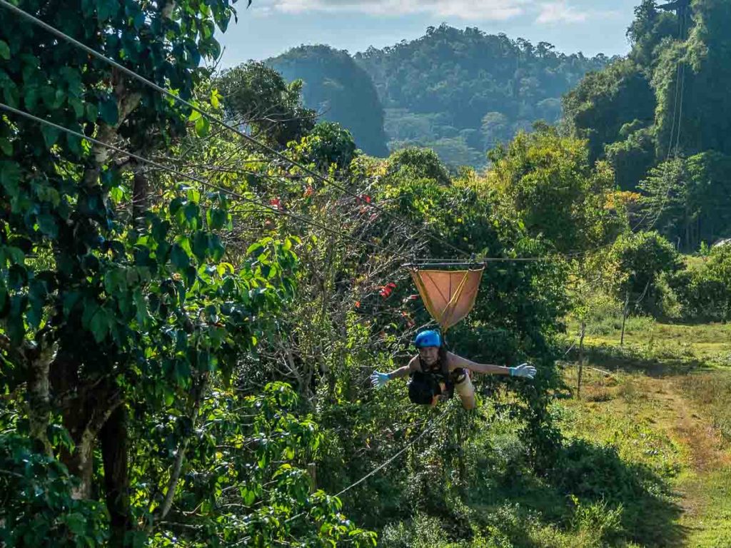 Boy ziplining superman style 71m down Ugong Rock - Palawan Adventure