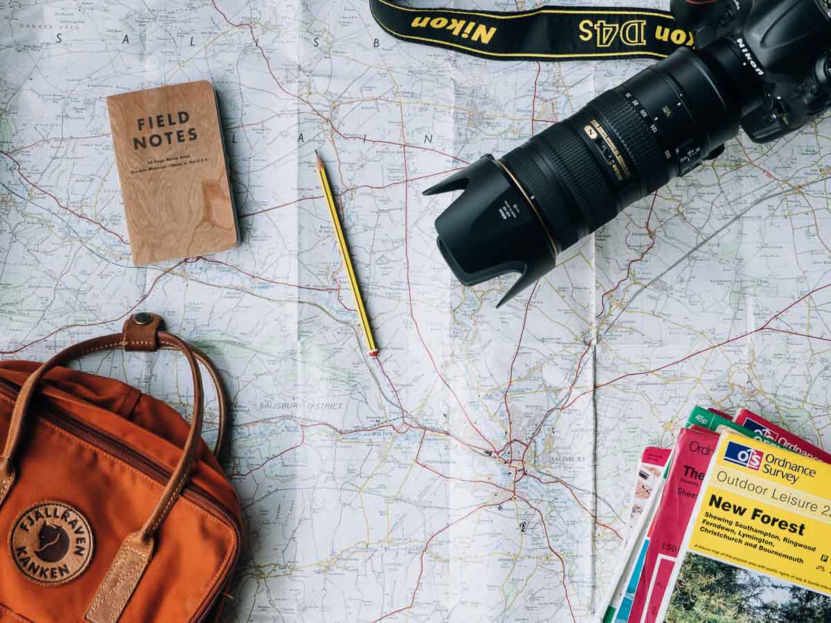 Flat Lay of Map with Camera Backpack Outdoor Guides Notebook - Pre-trip