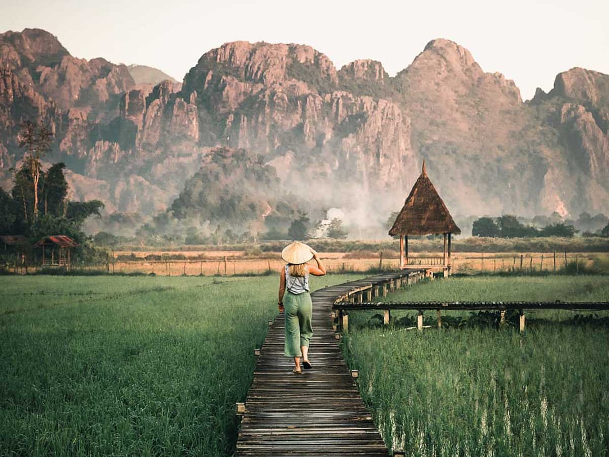 Walking in the rice paddy fields of Vang Vieng Laos - lesser-known destinations