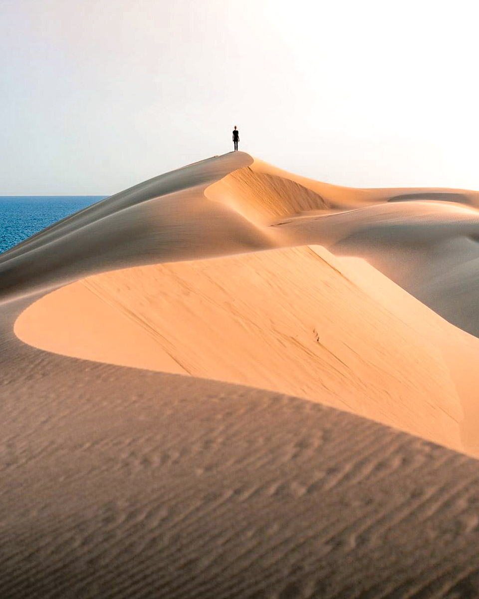 Person Standing on Stockton Sand Dunes - Instagrammable Places to Visit in New South Wales