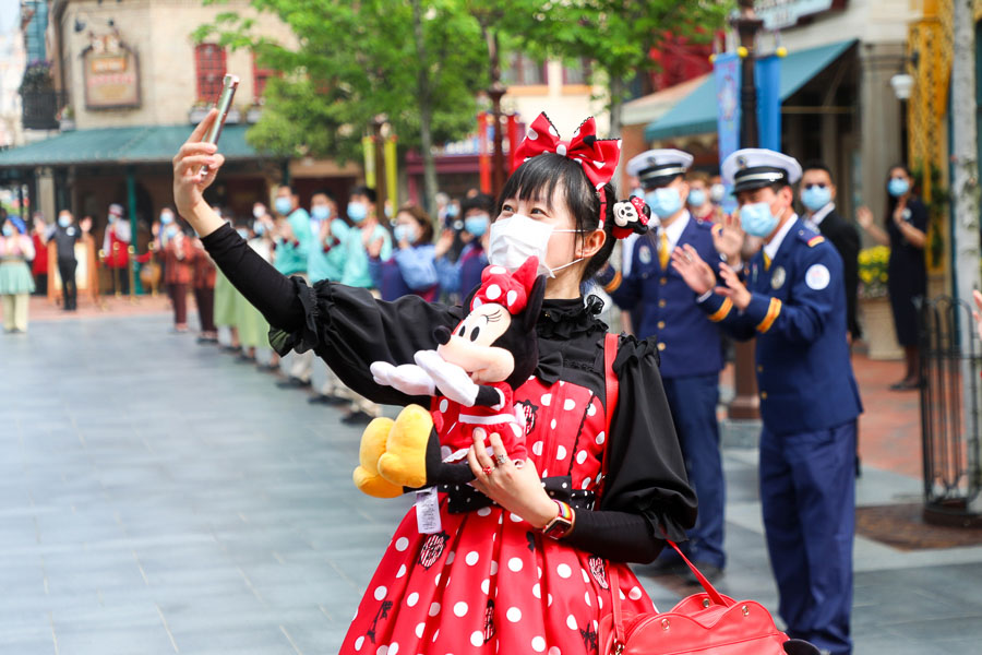 Guests with mask in Shanghai Disneyland - Theme parks reopen after COVID