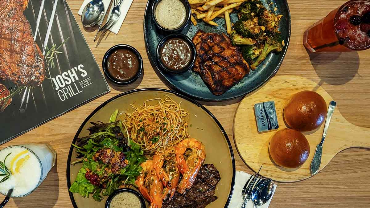 Flatlay of Josh's Grill Sirloin Steak and Prawns Spicy Chicken Chop - Singapore Itinerary 