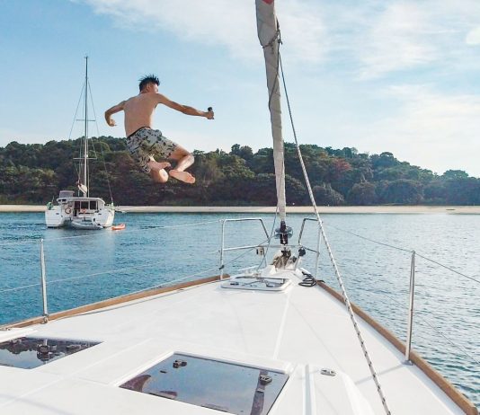 Guy jumping off a yacht - Yacht Getaway