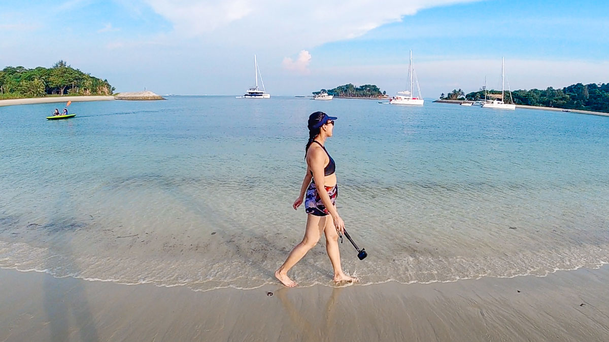 Girl walking along Lazarus Beach - Things to do in Singapore