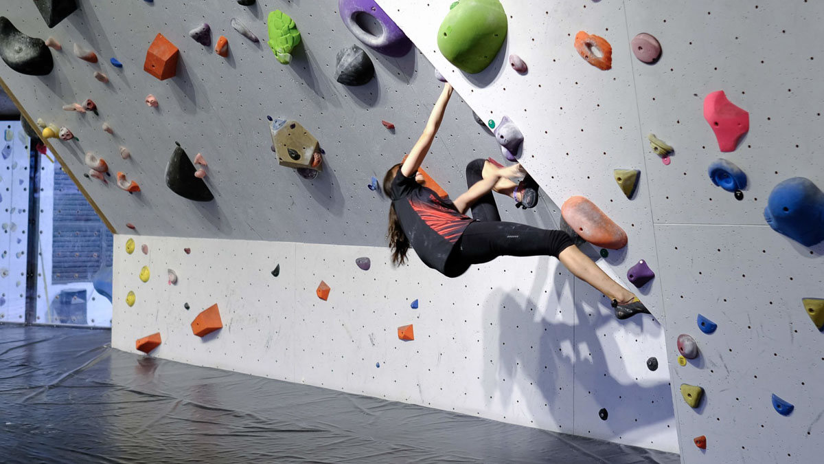 Girl bouldering at Ground Up Climbing