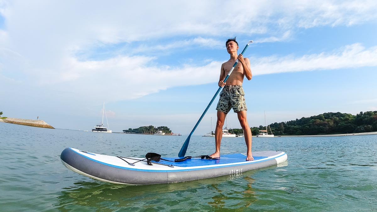 Guy paddleboarding by Lazarus Island - Southern Islands Staycation