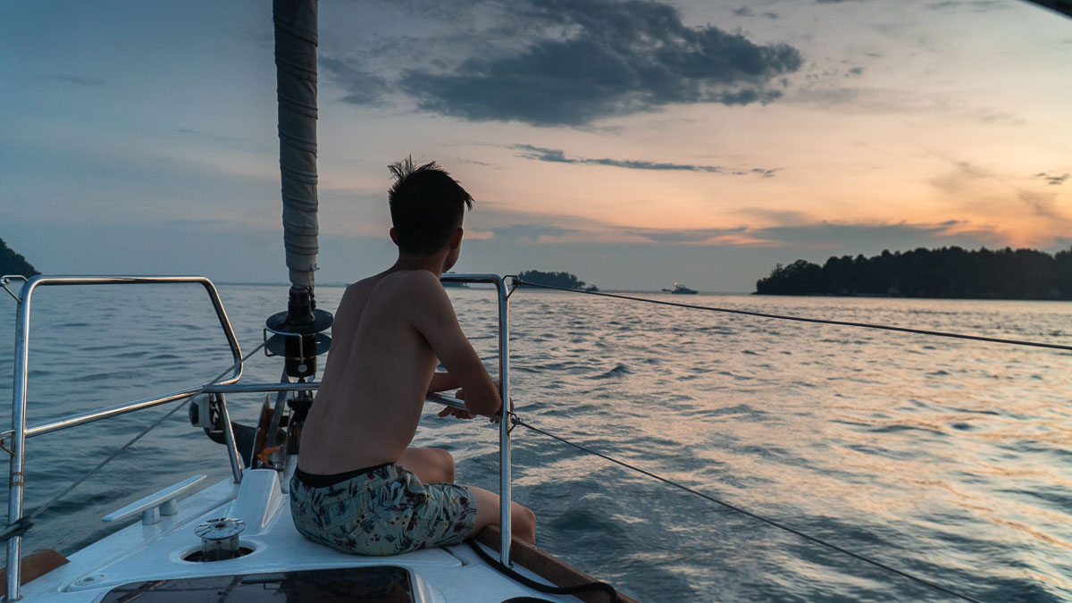 Guy enjoying the sunset on a yacht - Southern Islands Staycation