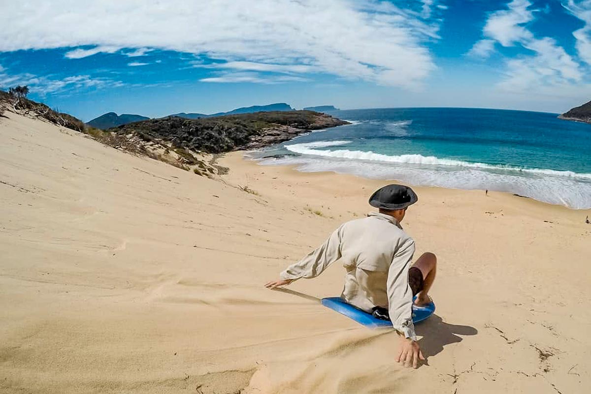 Tasmania Crescent Bay Sandboarding on Sand Dunes - Visit Australia
